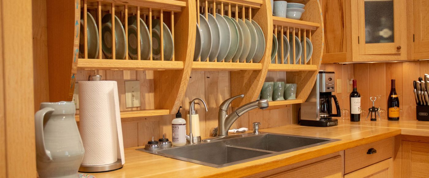 A Kitchen With Wooden Cabinets And A Sink