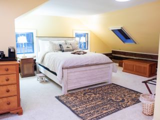 A Bedroom With A Bed And Desk In A Room